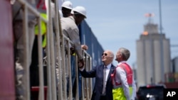 FILE - U.S. President Joe Biden and Chief Operating Officer of Lobito Atlantic Railway Nicolas Gregoire meet rail workers during a tour of the Lobito Port Terminal in Lobito, Angola, Dec. 4, 2024.