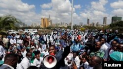 FILE - Ouma Oluga, Secretary-General of the Kenya Medical Practitioners, Pharmacists and Dentist Union (KMPDU), addresses doctors outside Ministry of Health headquarters in Nairobi, Kenya, Dec. 5, 2016. 