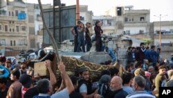 People attend the funeral of fighters killed in an airstrike in the town of Idlib, Syria, October 26, 2020. 