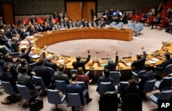 FILE - The U.N. Security Council votes unanimously to adopt a resolution concerning humanitarian aid in Syria at United Nations headquarters, Dec. 19, 2016.