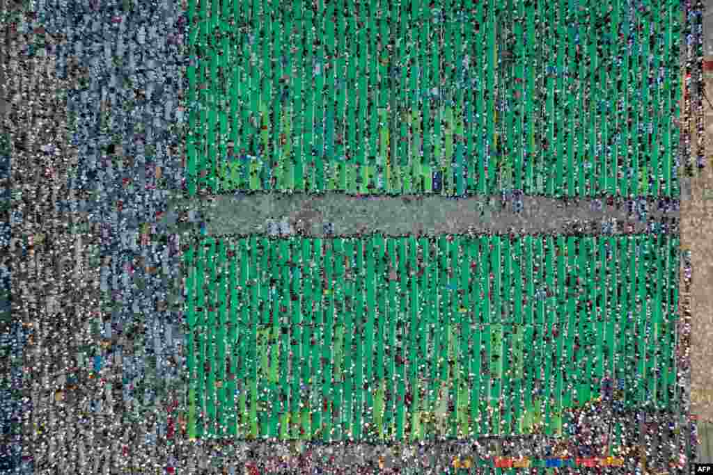 This aerial view shows Muslims attending the Eid al-Adha prayer at Skanderbeg Square in Tirana, Albania.