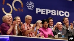 FILE - PepsiCo Chairwoman and CEO Indra K. Nooyi, center, is applauded as she rings the New York Stock Exchange opening bell to celebrate the 50th anniversary of the merger of Frito-Lay and Pepsi-Cola, June 8, 2015.