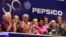 FILE - PepsiCo Chairwoman and CEO Indra K. Nooyi, center, is applauded as she rings the New York Stock Exchange opening bell to celebrate the 50th anniversary of the merger of Frito-Lay and Pepsi-Cola, June 8, 2015.