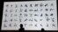 Japan's 4x100 metre relay Rio 2016 silver medallist Shota Iizuka (L) and national karate team member Kiyo Shimizu (R) look at a monitor displaying sports pictograms for the Tokyo 2020 Olympic Games during an unveiling ceremony in Tokyo, March 12, 2019. 
