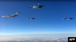 FILE - A video grab made on March 15, 2016, shows an image taken from footage made available on the Russian Defence Ministry's official website on March 15, 2016, reportedly showing Russian planes flying from an airbase in Syria.