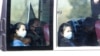 People wear masks as they ride on a public bus in Pyongyang, North Korea, Feb. 26, 2020. 