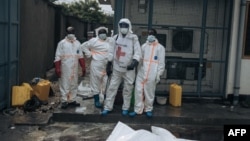 Members of the Congolese Red Cross stand amid bodies in body bags at the morgue of Goma General Hospital on Feb. 1, 2025.