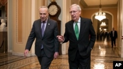 FILE - Senate Republican Majority Leader Mitch McConnell, and Senate Democratic Minority Leader Chuck Schumer left, walk toward the Senate chamber at the U.S. Capitol, in Washington, Feb. 7, 2018.