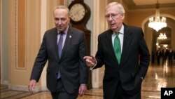 Senate Majority Leader Mitch McConnell, R-Kentucky, right, and Senate Minority Leader Chuck Schumer, D-New York, walk to the chamber after collaborating on a budget deal at the Capitol, in Washington, Feb. 7, 2018.