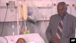Peter Kamau with a patient
