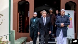 United Nations Secretary-General Antonio Guterres, center, walks with at Al Noor Mosque Imam Gamal Fouda, right, in Christchurch, New Zealand, Tuesday, May 14, 2019.