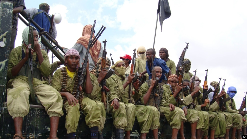 FILE - Al-Shabab fighters sit on a truck as they patrol in Mogadishu, Somalia, Oct. 30, 2009. The U.S. military says its airstrike killed at least nine militants. However, the Somalia government says its soldiers were killed in the strike.