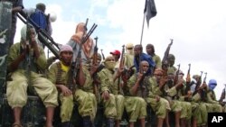 FILE - Al-Shabab fighters sit on a truck as they patrol in Mogadishu, Somalia, Oct. 30, 2009. The U.S. military says its airstrike killed at least nine militants. However, the Somalia government says its soldiers were killed in the strike.