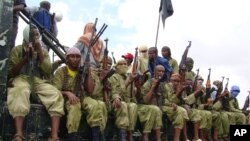 FILE - Al-Shabab fighters sit on a truck as they patrol in Mogadishu, Somalia, Oct. 30, 2009.