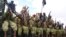 FILE - Al-Shabab fighters sit on a truck as they patrol in Mogadishu, Somalia, Oct. 30, 2009.