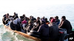 FILE - Migrants, mainly from sub Saharan Africa, are stopped by Tunisian Maritime National Guard at sea during an attempt to get to Italy, near the coast of Sfax, Tunisia, April 18, 2023.
