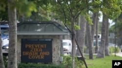 A sign at the entrance of one Florida town reminds residents to drain or cover standing water to prevent mosquitoes from reproducing in Key Biscayne, Florida, Aug. 17, 2016. 