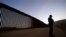 FILE - Border Patrol agent Justin Castrejon speaks in front of newly replaced border wall sections, Sept. 24, 2020, near Tecate, Calif. 