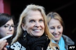 FILE - U.S. Ambassador to France Jane Hartley attends an event for the loading of two barrels of 250 liters of Hennessy cognac aboard the French frigate 'Hermione' in La Rochelle, western France, March 13, 2015.