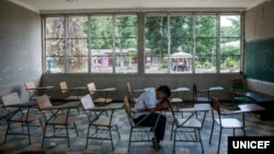In this photo taken August 31, 2018, in Villanueva, Honduras, Darwin Martinez, 16, sits in the classroom he shared with his friend Henry, who committed suicide in September of 2016. According to a teacher, Henry and Darwin were targeted by bullies. (Adiana Zehbrauskas/UNICEF)