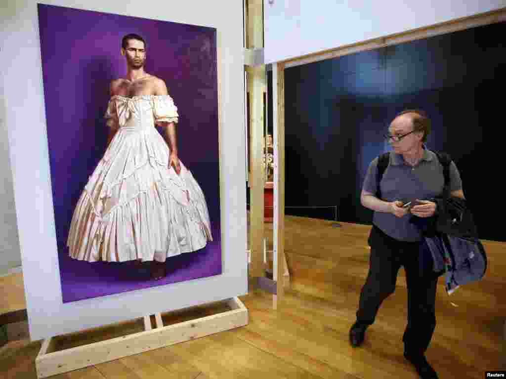A man walks past a painting by German artist Anke Doberauer at the Museum of Civilizations from Europe and the Mediterranean (MuCEM) in Marseille, France. 