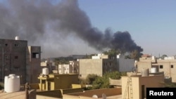 (FILE) Smoke rises amid clashes between armed factions in Libya.