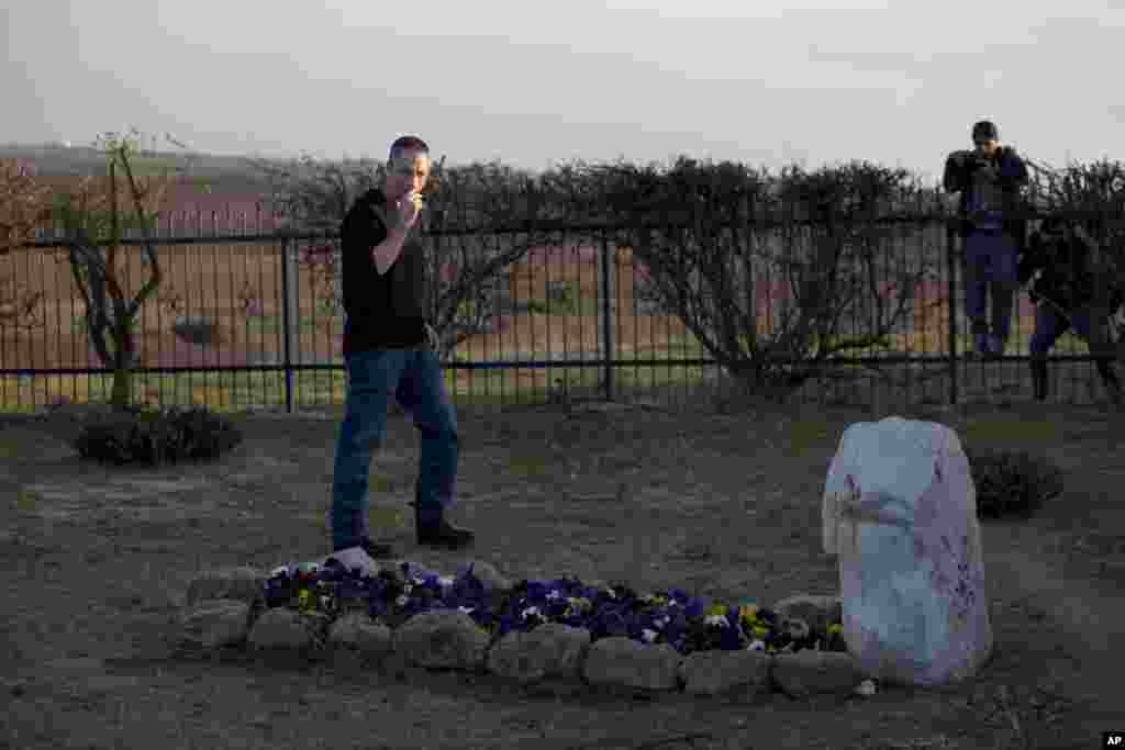 Gilad Sharon visits his mother's grave, where his father, the late Israeli Prime minister Ariel Sharon, is expected to be buried, outside Sharon's farm in Havat Hashikmim, southern Israel, Jan. 11, 2014. 