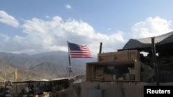 FILE - A U.S. flag is seen at a post in Deh Bala district, Nangarhar province, Afghanistan, July 7, 2018.