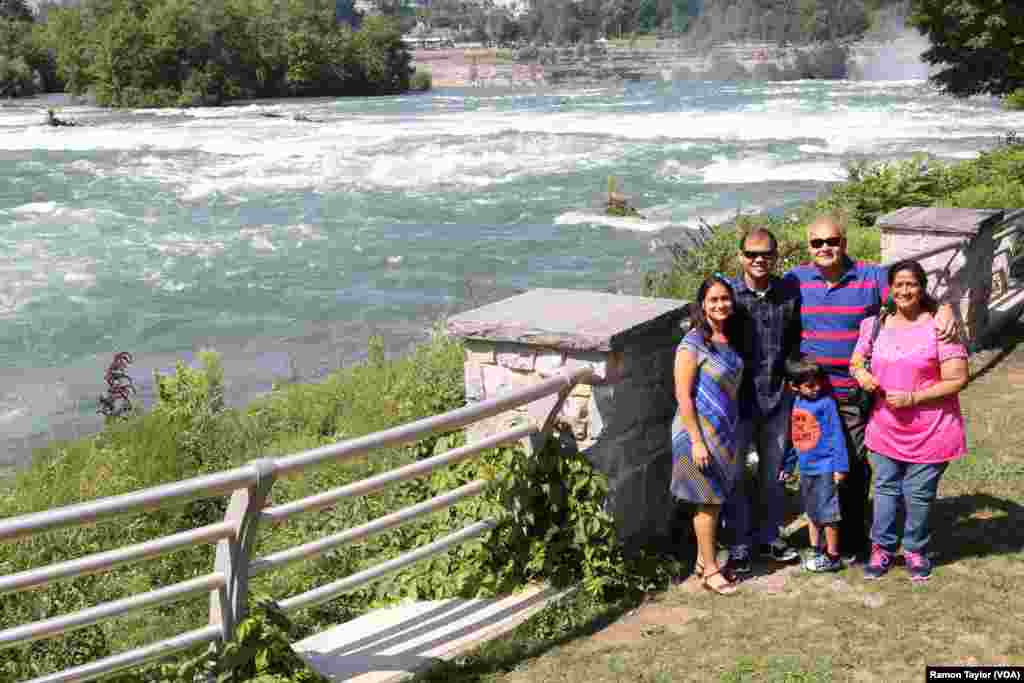 Vikas and Madhavi Vijay drove from Cleveland, Ohio, to Niagara Falls State Park to show their son and visiting parents “the pressure of the waterfalls” and experience the ‘Maid of the Mist’ boat ride. (R. Taylor/VOA)