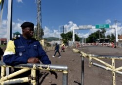 FILE - A police officer stands at the deserted crossing point between the Democratic Republic of Congo and Rwanda amid concerns about the spread of coronavirus disease (COVID-19).