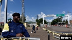 A police officer stands at the deserted crossing point between the Democratic Republic of Congo and Rwanda amid concerns about the spread of coronavirus disease (COVID-19).