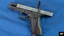 FILE: Glock 17 semi-automatic pistol fitted a with a cable style gun lock in Philadelphia, Pennsylvania on Wed. May 10, 2023