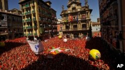 People gather for the launch of a firework rocket, known as the "Chupinazo", to celebrate the official opening of the 2016 San Fermin festival, in Pamplona, northern Spain, July 6, 2016. 