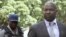 Zimbabwe's Prosecutor General Johannes Tomana (R) arrives escorted by policemen at the Harare Magistrates court, Feb. 2, 2016. 