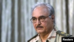 FILE - Field Marshal Khalifa Haftar attends a news conference in Abyar, east of Benghazi, Libya, May 17, 2014. 