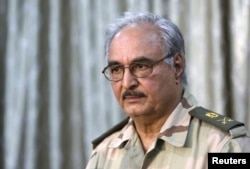 FILE - General Khalifa Haftar attends a news conference in Abyar, east of Benghazi, May 17, 2014.