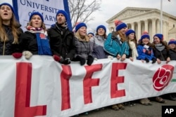 Anti-abortion activists march past the Supreme Court in Washington, Friday, Jan. 27, 2017, during the annual March for Life.