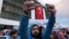FILE - Thousands of people gather in solidarity outside Zaman newspaper in Istanbul after a local court ordered that Turkey's largest-circulation, opposition newspaper — which is linked to U.S.-based Muslim cleric Fethullah Gulen — be placed under the management of trustees, March 4, 2016.