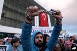 Thousands of people gather in solidarity outside Zaman newspaper in Istanbul, after a local court ordered that Turkey's largest-circulation, opposition newspaper be placed under the management of trustees, March 4, 2016.