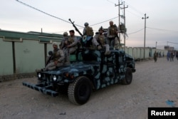 Iraqi Kurdish security forces patrol a street in Kirkuk, Iraq, Oct. 22, 2016.