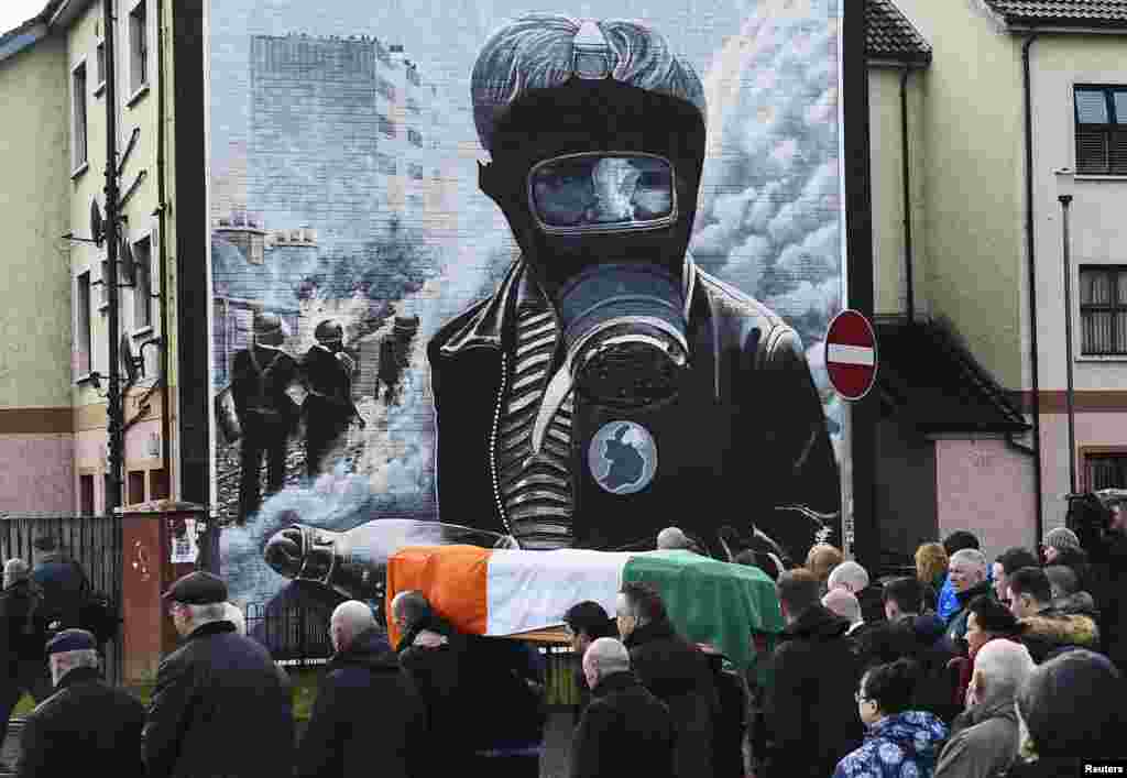 Pall bearers carry the coffin of Martin McGuinness through the streets of Londonderry, Northern Ireland. McGuinness was the Irish Republican Army warlord who led his underground, paramilitary movement toward reconciliation with Britain, and deputy First Minister for a decade in a power-sharing government.