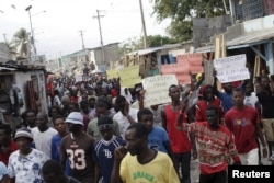 Protesters march during a demonstration against the government in Port-au-Prince, Haiti, Jan. 25, 2016.
