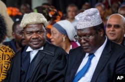 FILE - Lawyers Miguna Miguna, right, and Tom "T.J." Kajwang attend a mock "swearing-in" ceremony for opposition leader Raila Odinga at Uhuru Park in downtown Nairobi, Kenya, Jan. 30, 2018.