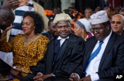 FILE - Lawyers Miguna Miguna (R), and Tom "T.J." Kajwang (C) attend a mock "swearing-in" ceremony for opposition leader Raila Odinga at Uhuru Park in downtown Nairobi, Kenya, Jan. 30, 2018.