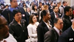 FILE - Job seekers attend a job fair sponsored by the Hispanic Alliance for Career Enhancement in New York, April 26, 2006. On average, Latinas in the United States are paid 54 cents for every dollar that a white, non-Hispanic male makes.