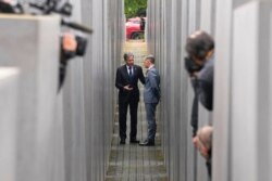 Media cover U.S. Secretary of State Antony Blinken, left, and German Foreign Minister Heiko Maas as they talk inside the Holocaust Memorial, in Berlin, Germany, June 24, 2021.