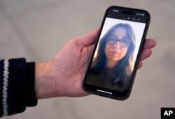 A cellphone photo of artist and Palisades Fire survivor Kathryn Andrews is held by gallery director Ariel Pittman, Jan. 16, 2025, in Los Angeles.