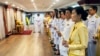 Participants hold lit candles and take part in a moment of silence for 89 seconds to remember King Rama IX, during the candle-lighting ceremony to pay homage to King Bhumibol Adulyadej's Memorial Day at the Royal Thai Embassy Washington, DC. Oct 11, 2019.