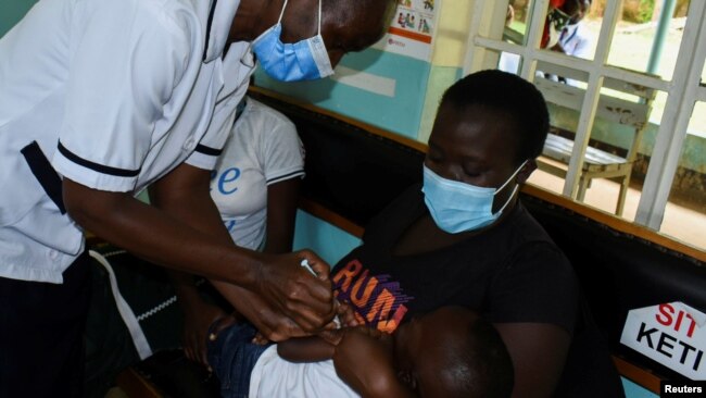 Pamela Omboko administers a malaria vaccine to Jeywellan Ochieng, 2, at the Yala Sub County Hospital Mother and Child Healthcare (MCH) clinic in Gem, Siaya County, Kenya, Oct. 7, 2021.