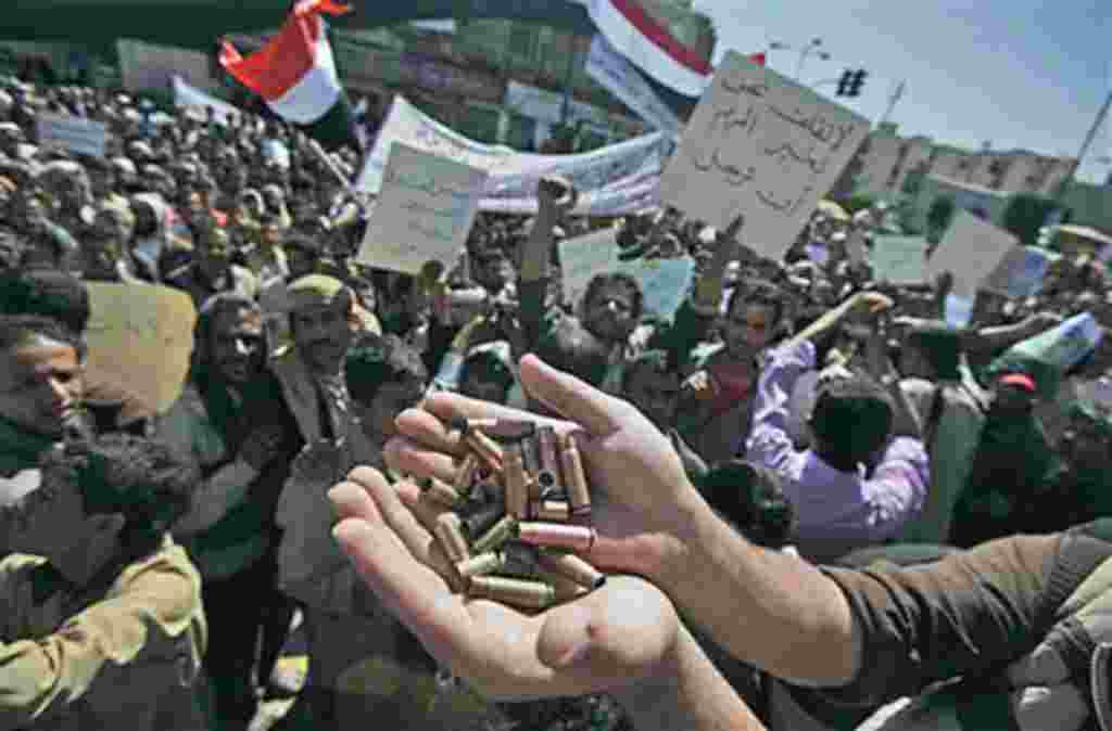 An anti-government protestor displays bullet shells, claiming they were fired at demonstrators Tuesday night by Yemeni government supporters, killing at least one demonstrator, while demanding resignation of President Ali Abdullah Saleh, in Sanaa, Yemen, 